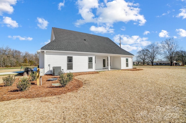 rear view of property with central AC unit