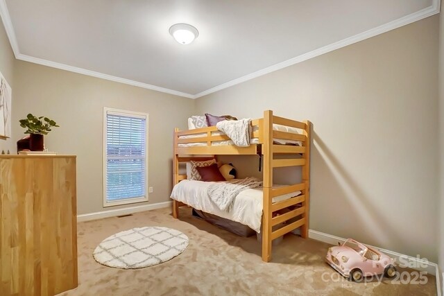 carpeted bedroom with ornamental molding