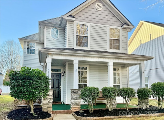 view of front of home featuring a porch and a shingled roof