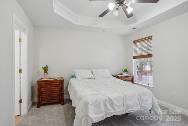 bedroom featuring light carpet, crown molding, a raised ceiling, and baseboards