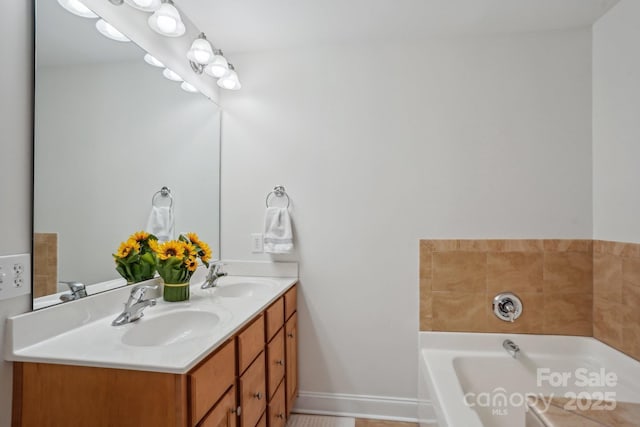 bathroom with a garden tub, double vanity, baseboards, and a sink