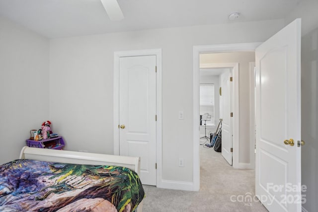 bedroom with light carpet, ceiling fan, and baseboards