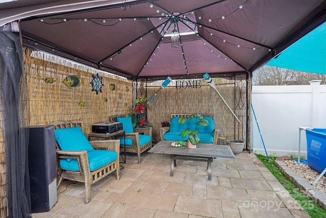 view of patio featuring a gazebo, a fenced backyard, and outdoor lounge area