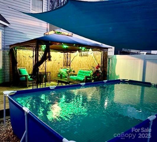 view of pool with a gazebo, a fenced in pool, and a fenced backyard