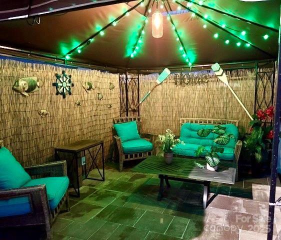 view of patio / terrace with a gazebo, an outdoor hangout area, and fence