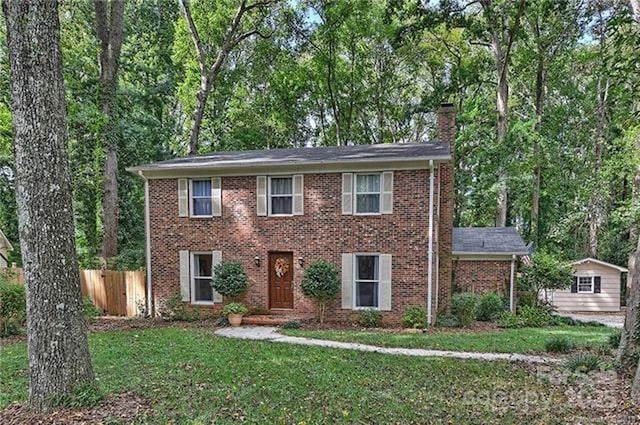 colonial home with a front lawn