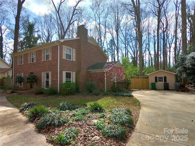 view of side of home featuring a garage and an outbuilding