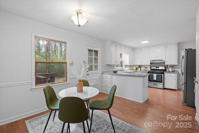 dining space featuring sink and light wood-type flooring