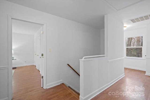 corridor with light hardwood / wood-style floors