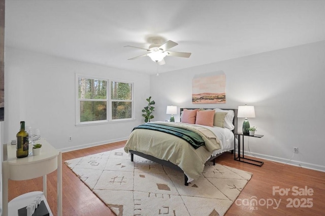 bedroom with ceiling fan and light wood-type flooring