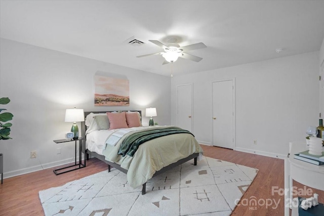 bedroom with ceiling fan and light hardwood / wood-style floors