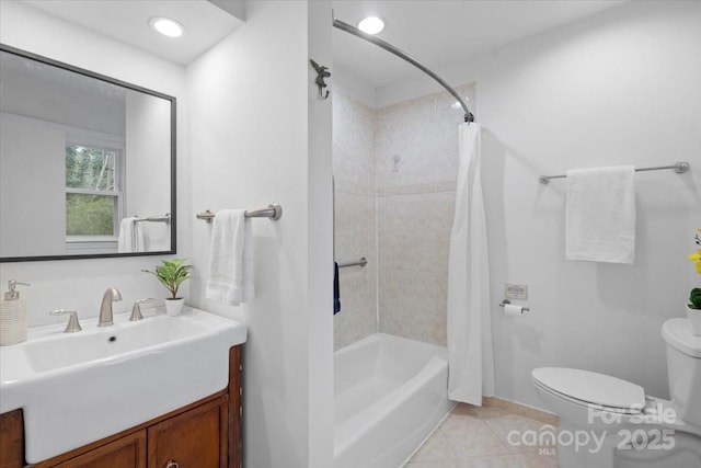 full bathroom featuring shower / bath combo with shower curtain, toilet, vanity, and tile patterned flooring