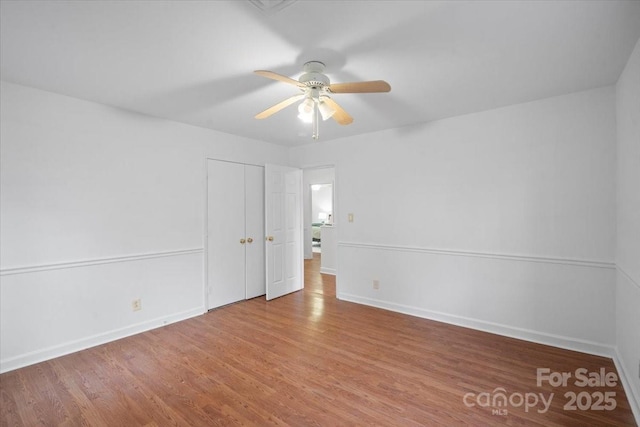 empty room featuring hardwood / wood-style flooring and ceiling fan