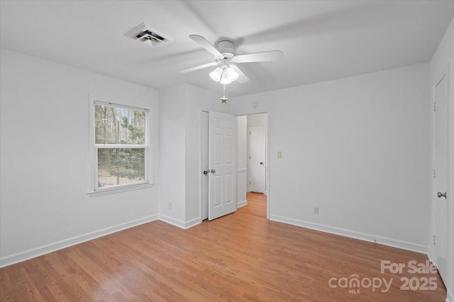 spare room with ceiling fan and light hardwood / wood-style flooring