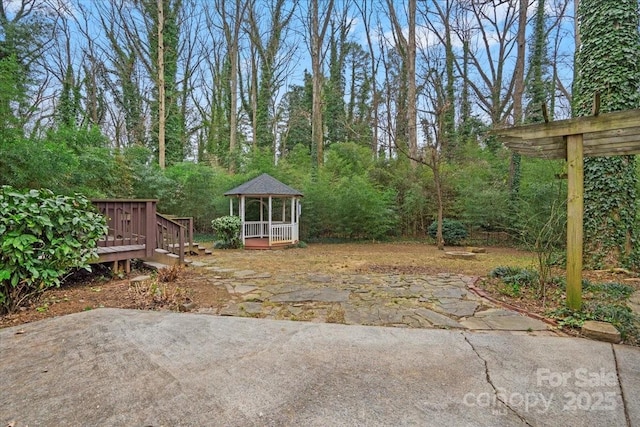 view of yard with a gazebo and a wooden deck