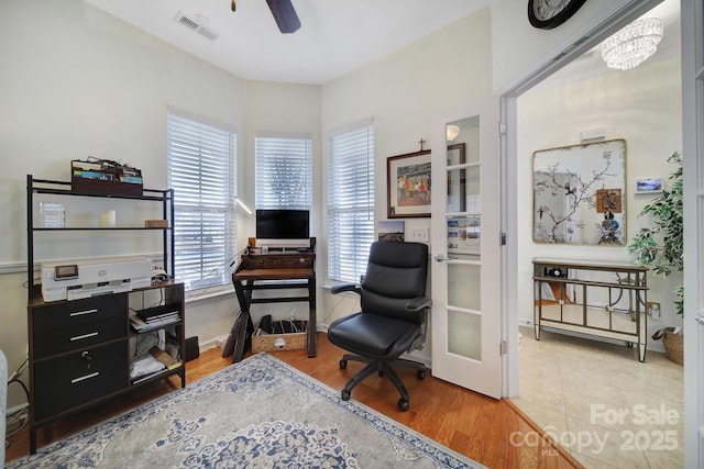 office area featuring ceiling fan with notable chandelier and hardwood / wood-style flooring