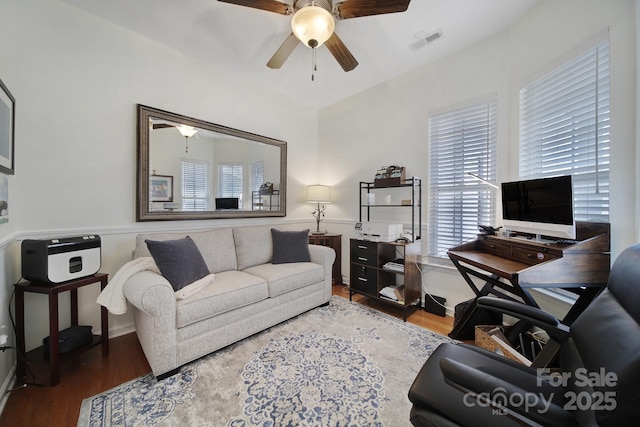 living room featuring ceiling fan and hardwood / wood-style floors