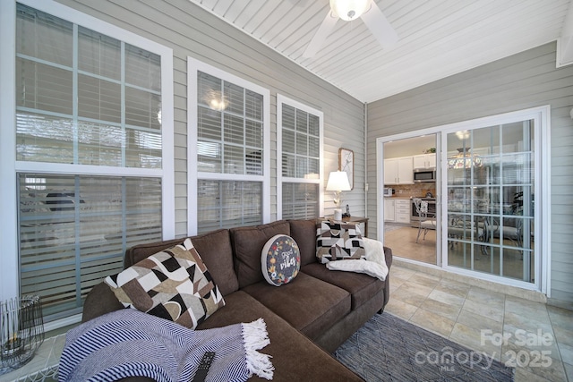 sunroom featuring ceiling fan