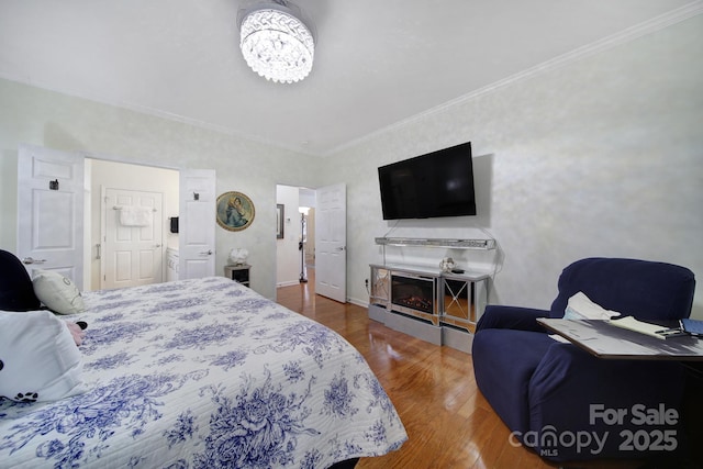 bedroom featuring hardwood / wood-style floors and ornamental molding