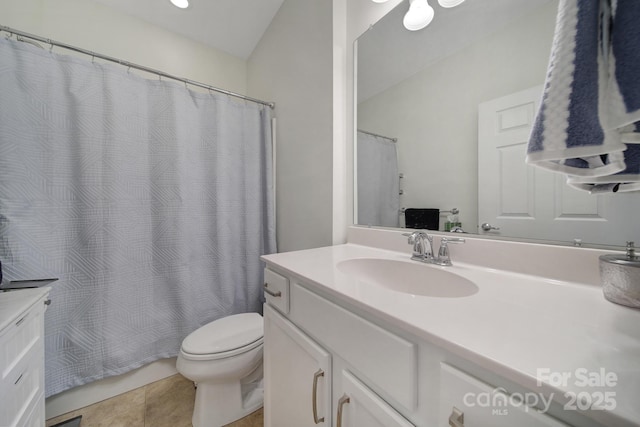 bathroom featuring toilet, tile patterned floors, and vanity