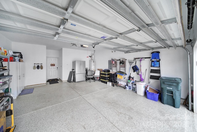 garage featuring stainless steel fridge, water heater, and a garage door opener