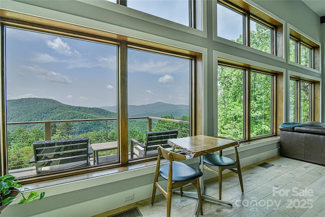 sunroom with a mountain view and a wealth of natural light