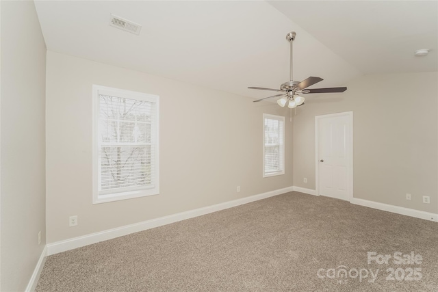 spare room featuring lofted ceiling, carpet floors, and ceiling fan