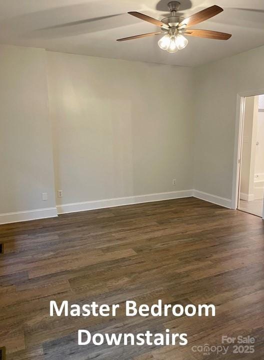 empty room with ceiling fan and dark wood-type flooring