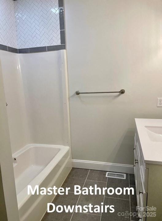 bathroom with vanity,  shower combination, and tile patterned floors