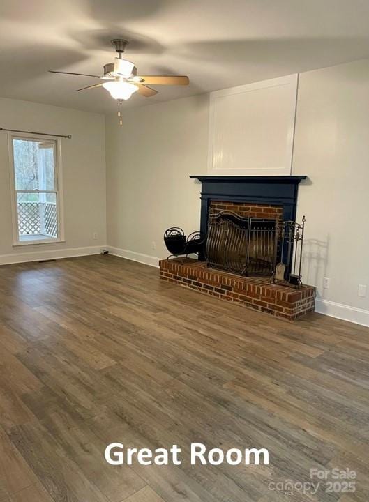 unfurnished living room with a fireplace, ceiling fan, and dark wood-type flooring