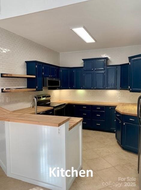 kitchen with butcher block countertops, stainless steel electric range, light tile patterned floors, and blue cabinetry