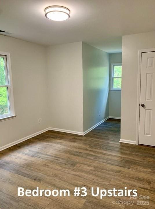 unfurnished room with dark hardwood / wood-style floors