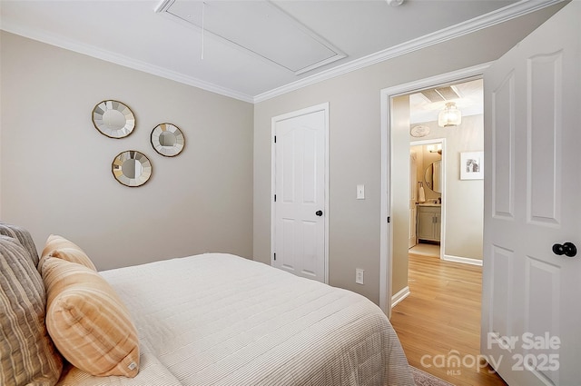 bedroom featuring light hardwood / wood-style flooring and ornamental molding