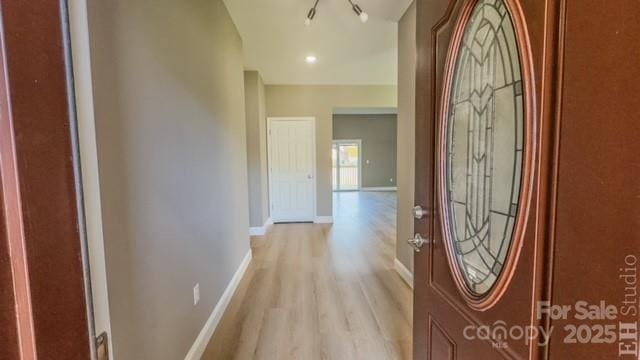 foyer featuring a notable chandelier and light wood-type flooring