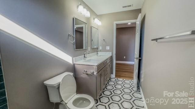 bathroom featuring vanity and toilet