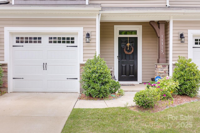 doorway to property with a garage