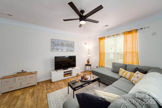 living room featuring crown molding, ceiling fan, and light wood-type flooring