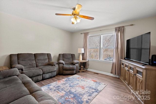 living room featuring ceiling fan and light wood-type flooring