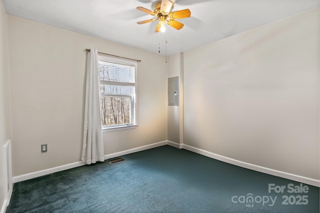 carpeted empty room featuring ceiling fan and electric panel