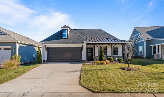 view of front of property with a garage, a front yard, and a porch