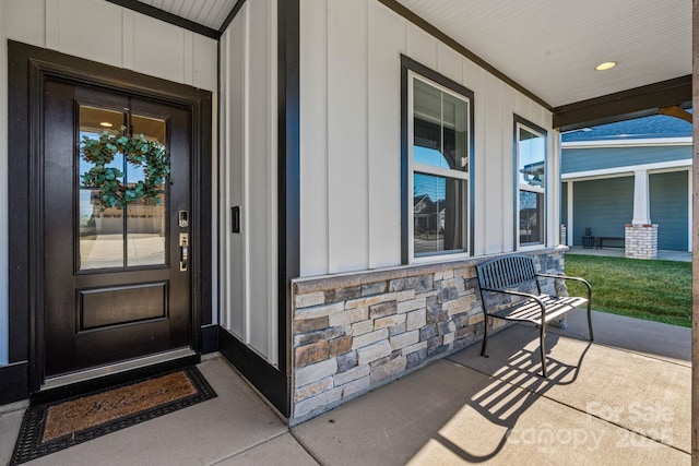 view of exterior entry with a porch