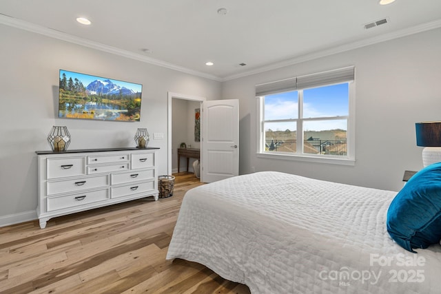 bedroom featuring light hardwood / wood-style floors and ornamental molding