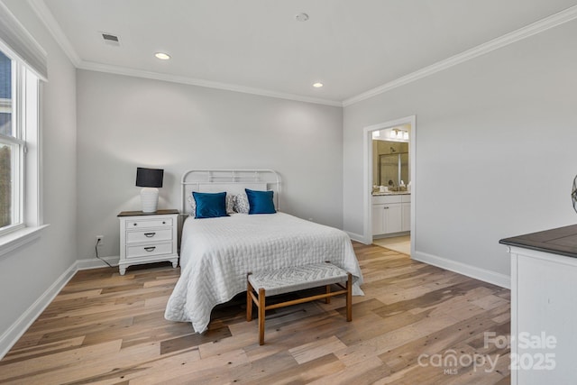 bedroom featuring ensuite bathroom, light hardwood / wood-style flooring, and crown molding