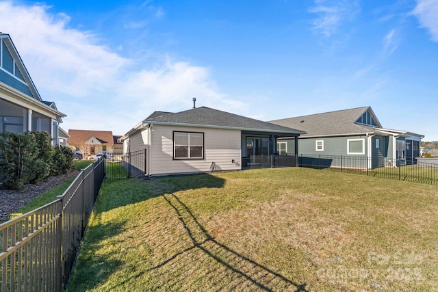 rear view of property featuring a yard