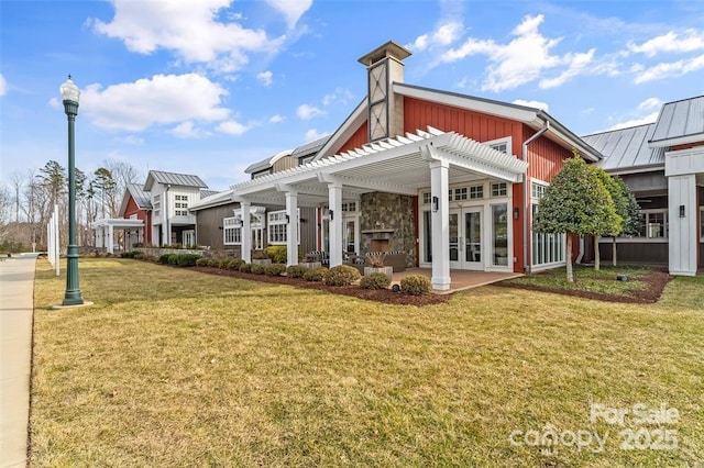 back of property with a patio, a yard, a fireplace, and a pergola