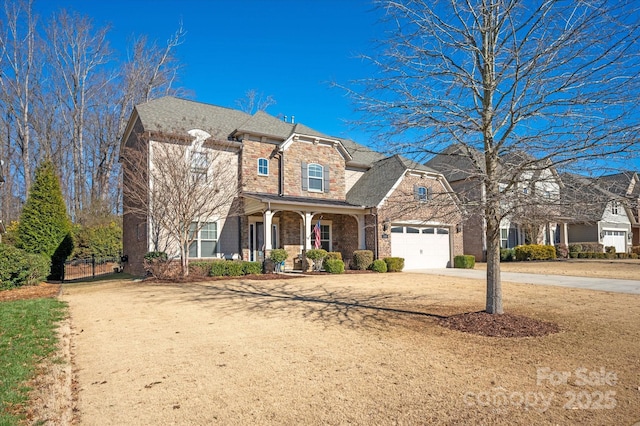 view of front of property with covered porch and a garage