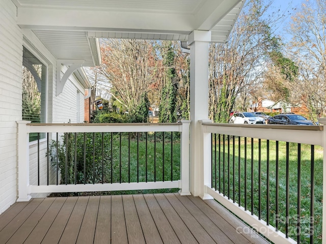 wooden terrace with a yard