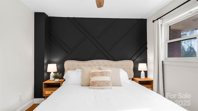 bedroom with ceiling fan and hardwood / wood-style floors