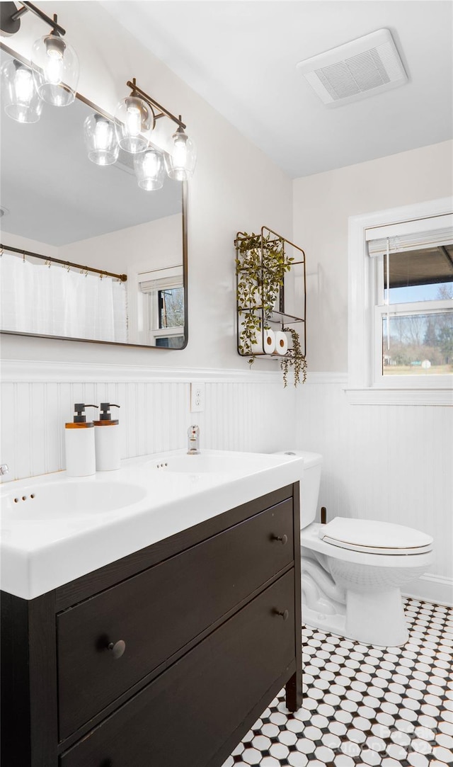 bathroom featuring vanity and toilet