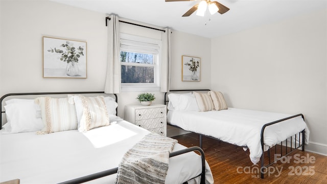 bedroom featuring ceiling fan and dark hardwood / wood-style flooring